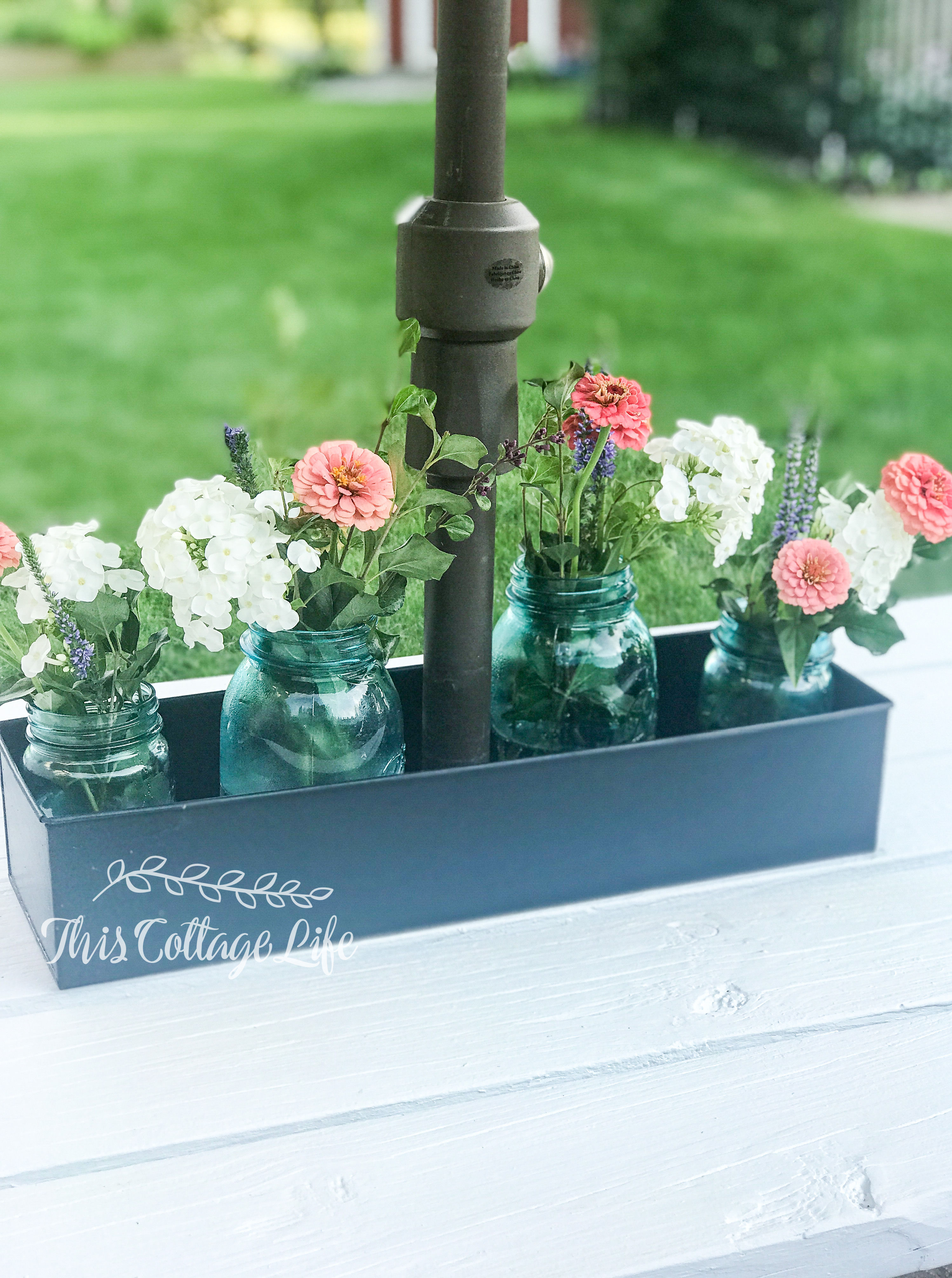 Mason jars arranged on umbrella table